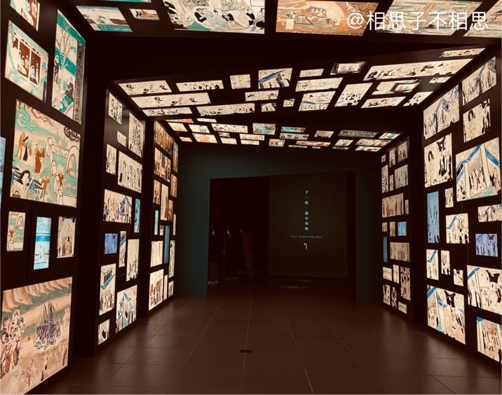 A room with many pictures on the wall

Description automatically generated