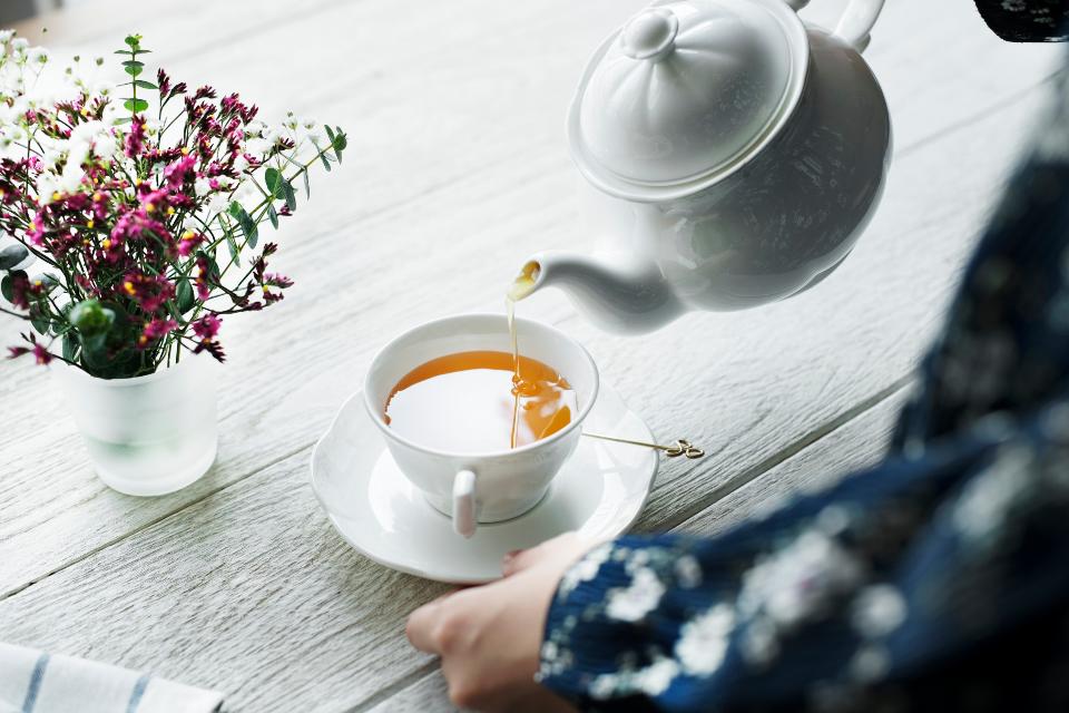 pouring tea cup afternoon beverage break cafe close up decoration drink enjoying feminine flower hand home hot drink lifestyle morning person simple minimal refreshment relax 